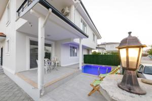 a patio with a table and chairs in a house at Lavender Villas in Dalaman