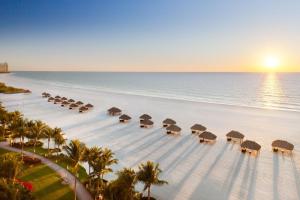 an aerial view of a beach with umbrellas and the ocean at JW Marriott Marco Island Beach Resort in Marco Island