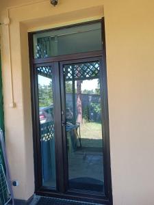 a sliding glass door with a view of a yard at Parkowe Ranczo in Poraj