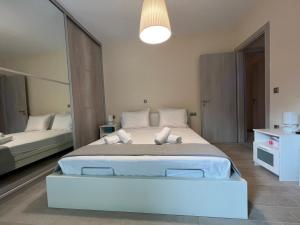 a bedroom with a large bed and a large mirror at Las Vergas - Enjoy our swimming pool in Kalamata, Greece in Kalamata +28 photos