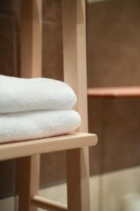 a stack of towels sitting on a shelf at Hygge Home Apartman in Eger