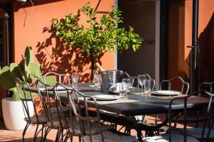 a black table with chairs and glasses on it at Villa Terme di Caracalla with private Swimming Pool in Rome