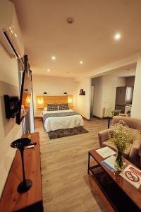 a hotel room with a bed and a couch at Casas Rurales El Tajo in Setenil