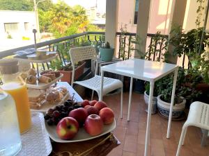 a table with plates of fruit on a balcony at Serenity B&B in Brescia