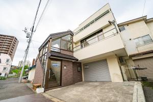 a building with its garage door open on a street at Ota Building - Vacation STAY 13994 in Otaru