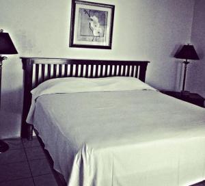 a black and white photo of a bed in a bedroom at Jamrock Secret Retreat in Montego Bay