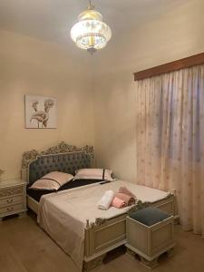 a bedroom with a bed and a chandelier at Ververa rooms in Missolonghi