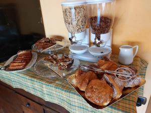 a table topped with bread and pastries on a table at Agriturismo Al Nido Degli Aironi in Sanremo