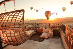 a hammock with hot air balloons in the sky at Simera in Cappadocia - Special Class in Uchisar