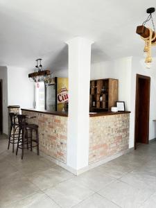 a bar in a room with a brick wall at Pensiunea Lili’s House in Buchin
