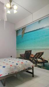 a bedroom with a bed and a mural of a beach at Comfy Home Near to Penang Hill in Ayer Itam