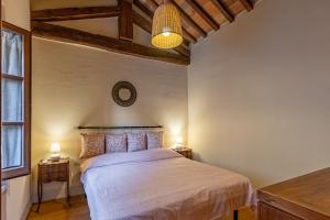 a bedroom with a large bed in a room at La Corte del Podestà in Sarteano +21 photos