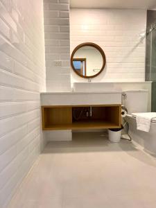 La salle de bains est pourvue d'un lavabo et d'un miroir. dans l'établissement Baannalin Hometel บ้านนลิน โฮมเทล, à Chiang Mai