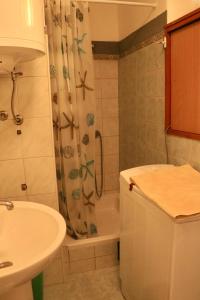 a bathroom with a sink and a shower curtain at Appartment Riva view in Šibenik