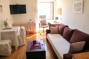 a living room with a couch and a table at Appartment Riva view in Šibenik