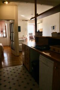 a kitchen with a counter and a living room at Appartment Riva view in Šibenik
