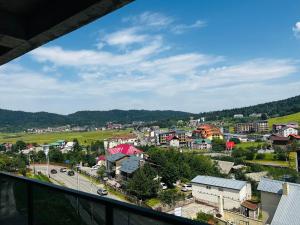 a view of a town from a balcony at BOBLINE BAKURIANI SUITE in Bakuriani