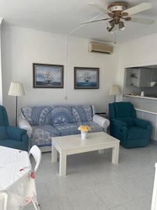 a living room with a couch and two chairs and a table at Apartamento la roca (Bajondillo) in Torremolinos