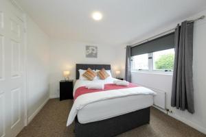a bedroom with a large bed and a window at Premier Apt - Bridge View-Rosyth in Rosyth