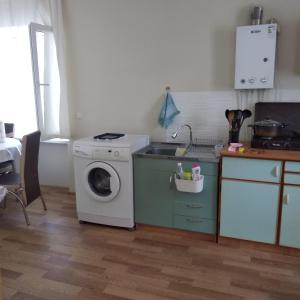 cocina con lavadora y fregadero en уют en Rustavi