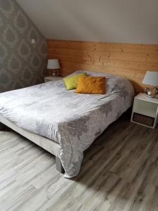 a bedroom with a large bed with a wooden floor at Marlibelle in Valff