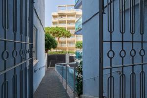 an alley with blue walls and a gate at Casa Ola in Salou