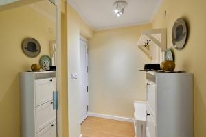 a hallway with a white staircase in a home at Casa Ola in Salou