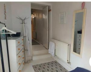 a room with a hallway with stairs and a mirror at Centrel to london single bed room quiet home with host and breakfast in London
