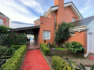 a brick house with a red carpet in front of it at !Chalet de lujo para vacaciones!... in Camargo