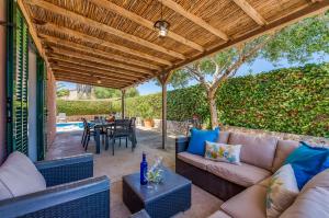 a patio with a couch and a table at Ideal Property Mallorca - Son Frau in Manacor