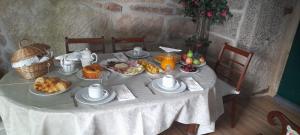 una mesa con un mantel blanco con comida. en Planalto Dourado 