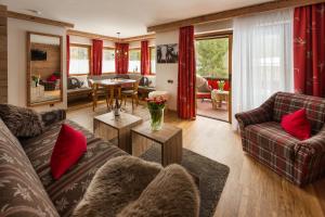 a living room with two couches and a table at Brunnenhof Oberstdorf - Ferienwohnungen mit Hotel Service in Oberstdorf