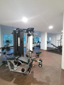 a gym with several tread machines in a room at Ilsham Guest House @ Seroja Hills BBST Sepang in Sepang