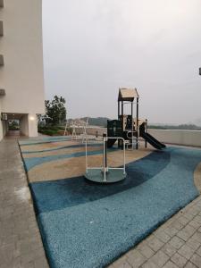 a playground in a building with a blue carpet at Ilsham Guest House @ Seroja Hills BBST Sepang in Sepang
