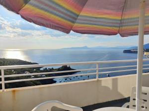 balcone con ombrellone e vista sull'oceano di Appartamento La Perla a San Nicola Arcella