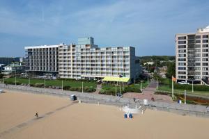 a view of a beach with a large building at Four Points by Sheraton Virginia Beach Oceanfront in Virginia Beach