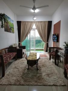 a living room with a couch and a table at Ilsham Guest House @ Seroja Hills BBST Sepang in Sepang