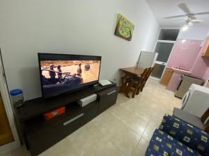 a living room with a flat screen tv on a cabinet at Gzira Centre Apartment in Il-Gżira