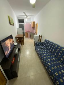 a living room with a couch and a flat screen tv at Gzira Centre Apartment in Il-Gżira
