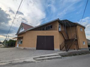 a house with a spiral staircase on the side of it at Гостиный дом in Otaci