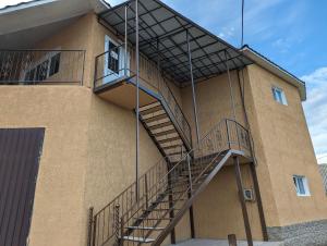 a spiral staircase on the side of a building at Гостиный дом in Otaci
