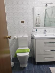 a bathroom with a white toilet and a sink at Casa Mara in Zamora