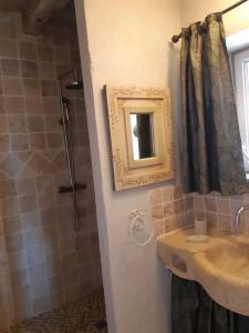 a bathroom with a sink and a mirror and a shower at Chez Sylvie in Excideuil +14 photos
