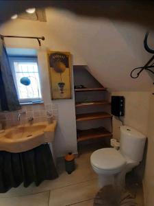 a bathroom with a sink and a toilet at Chez Sylvie in Excideuil