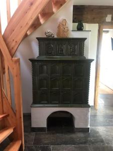 a black cabinet with a fireplace in a room at Sonniges Kellerstöckel im Schilcherland in Deutschlandsberg