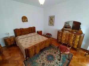 a bedroom with a bed and a dresser and a tv at Ca' Molino Giare 1 in Mira