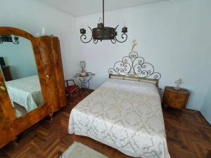 a bedroom with two beds and a mirror and a chandelier at Ca' Molino Giare 1 in Mira +3 photos