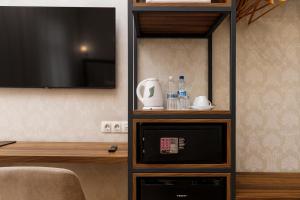 a entertainment center with a television in a room at Feder Boutique Hotel in Lviv