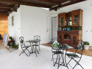 a patio with a table and chairs and a cabinet at Casa Margherita in Ponza