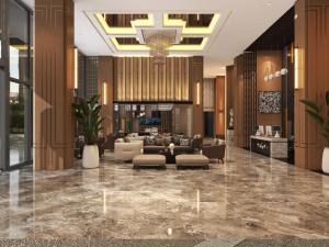 un vestíbulo de un hotel con sofás y sillas en Shi Lai De Executive Apartments, en Dongguan